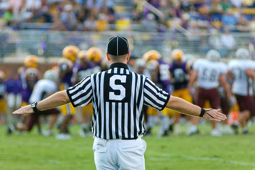 Referee on football field making a call