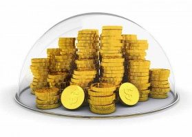 Gold coins stacked inside glass bubble indicating protection or insurance