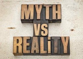 Myth versus reality wood printing press blocks against rustic white wood