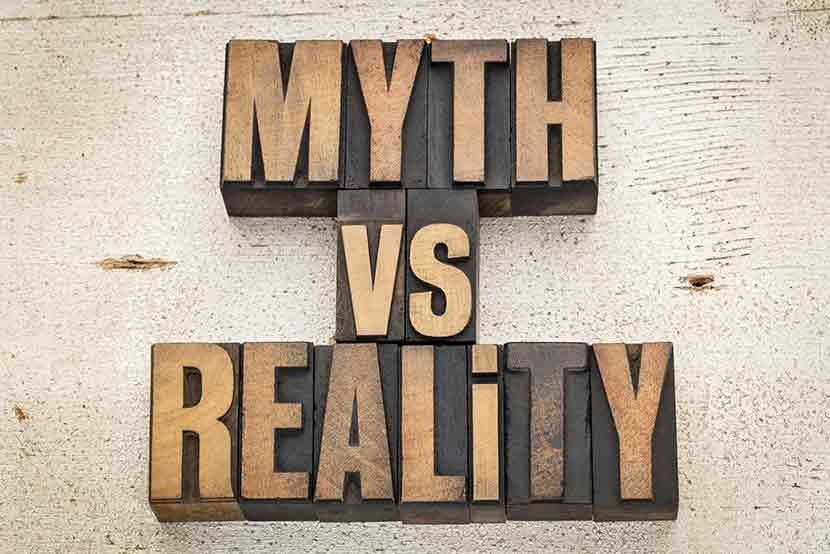 Myth versus reality wood printing press blocks against rustic white wood