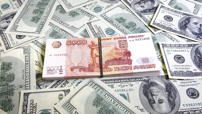 Stack of 5,000 denomination Russian ruble over stacks of dollars