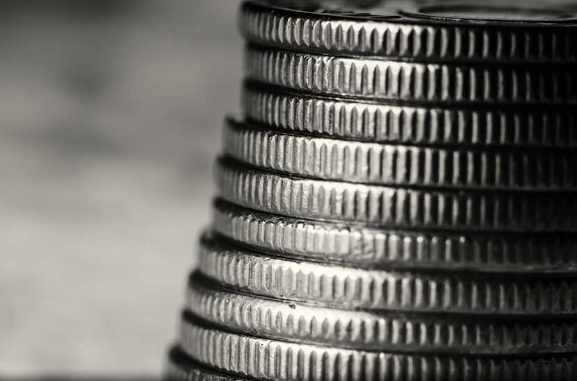 Magnified black and white view of the edge of a stack of platinum coins