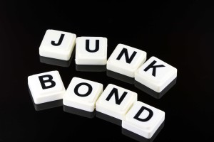 Individual white blocks with black letters spelling "Junk Bond" on black background