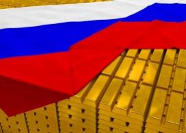Russian flag draped over neatly stacked gold bars