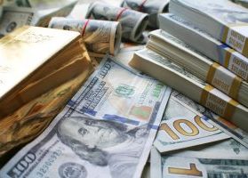 Gold bars and $100 bills, U.S. currency