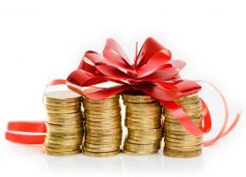 Four stacks of gold coins topped with large red ribbon