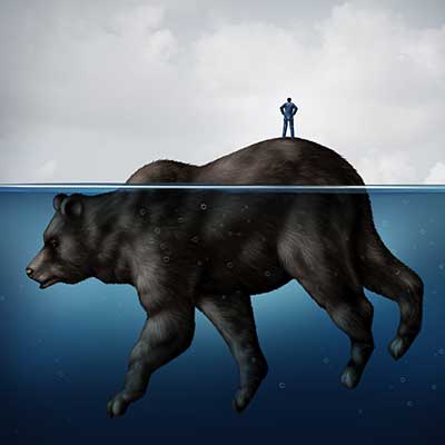 Business man standing on top of a giant bear that is sinking into the ocean