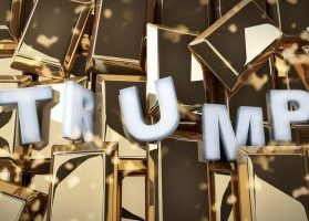 Silver letters spelling "Trump" against background of gold bars