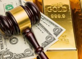 Courtroom gavel, U.S. dollar bills, and shiny gold bars
