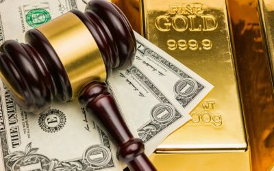 Courtroom gavel, U.S. dollar bills, and shiny gold bars
