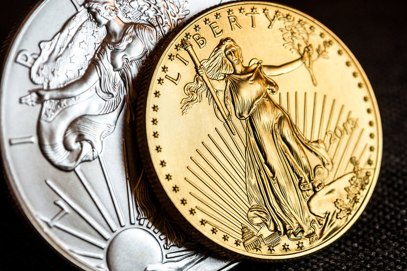 Silver American Eagle Coin and Gold American Eagle Coin on black background