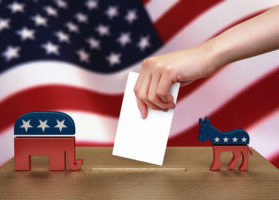 Hand with ballot and wooden box on Flag of USA