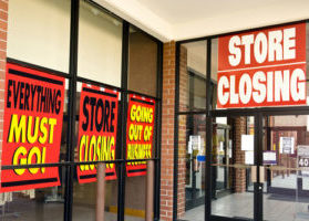 Everything must go store closing signs on business window