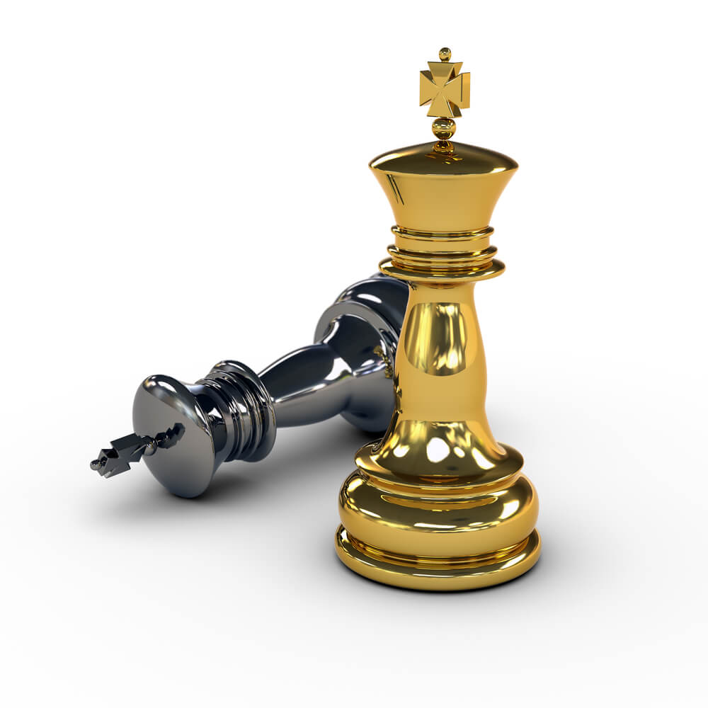 Gold and silver king chess pieces with silver chess piece on the ground