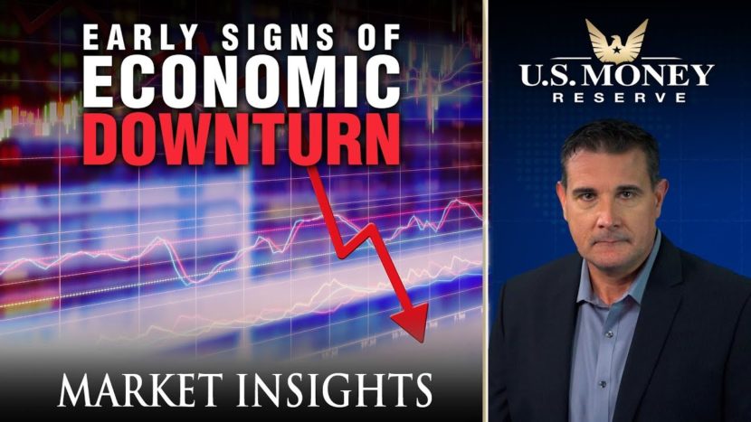 Coy Wells presenting signs of an economic downturn with a display of a purple graph and a red negative arrow