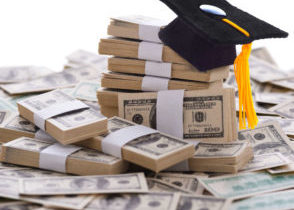 Graduation Cap Sitting on a Pile of Money