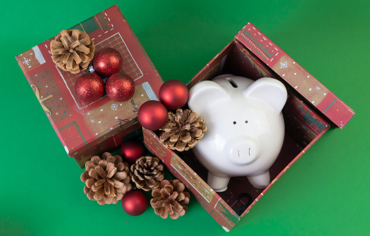 Piggy bank in open Christmas gift box
