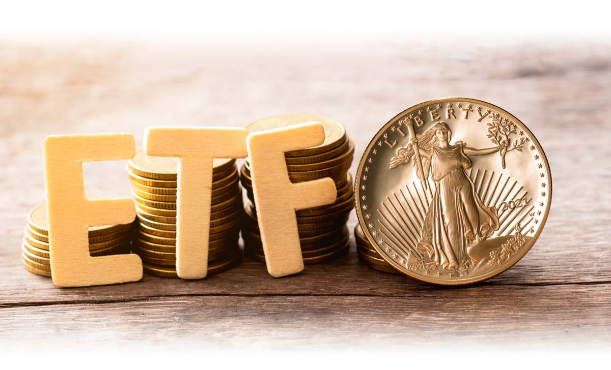 Letters spelling "ETF" beside stacks of Gold American Eagle coins
