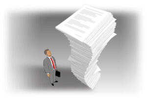 Business man looking up at towering stack of paper