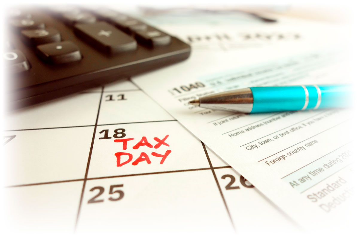 Calendar marking April 18 as Tax Day along with calculator and 1040 tax form
