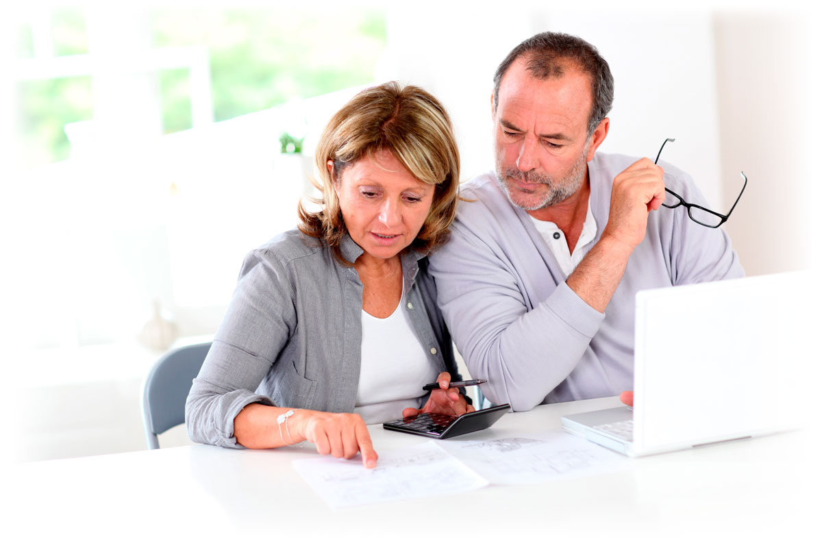 Couple examining financial documents with laptop and calculator