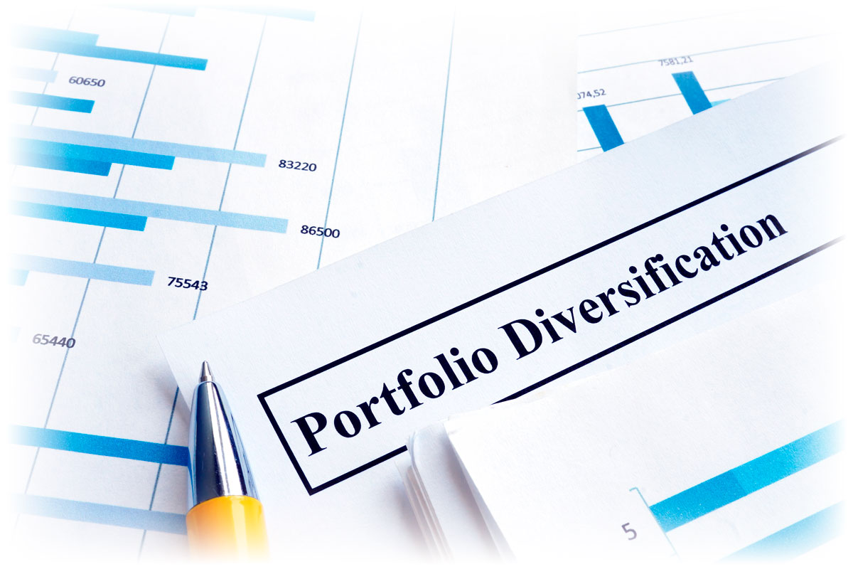 Pen resting on document labeled “Portfolio Diversification” and financial charts