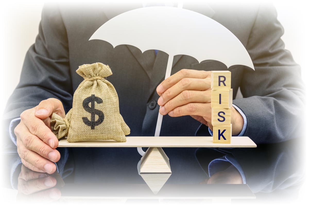 Business person balancing bags of money and letter blocks spelling “RISK”