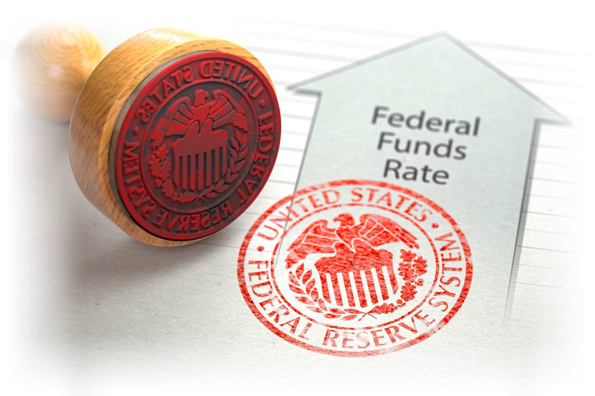 Federal Reserve System stamp next to upwards arrow marked "Federal Funds Rate"