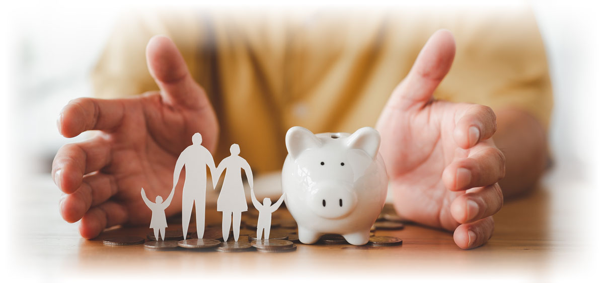 Hands surrounding paper cutout of family, piggy bank, and coins