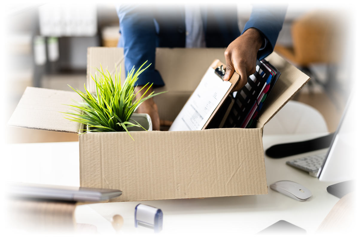 Business person packing up desk in cardboard box