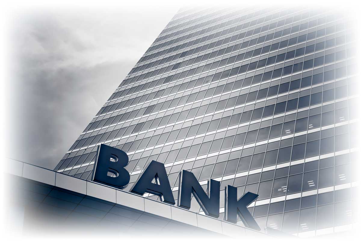 Black and white image of tall office building and "BANK" sign