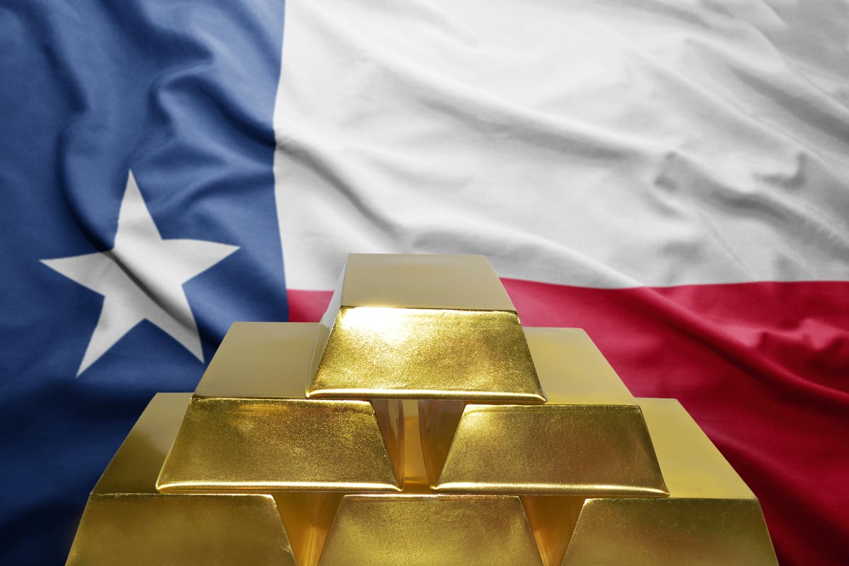 Gold bars stacked in front of a Texas state flag