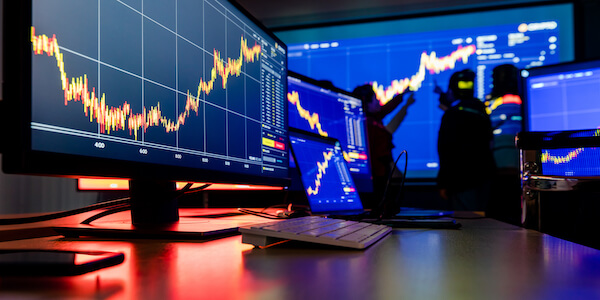 Analysts discussing upward-trending stock data