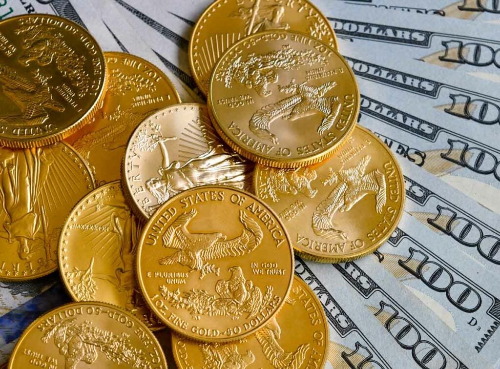 Gold American Eagle coins over $100 notes