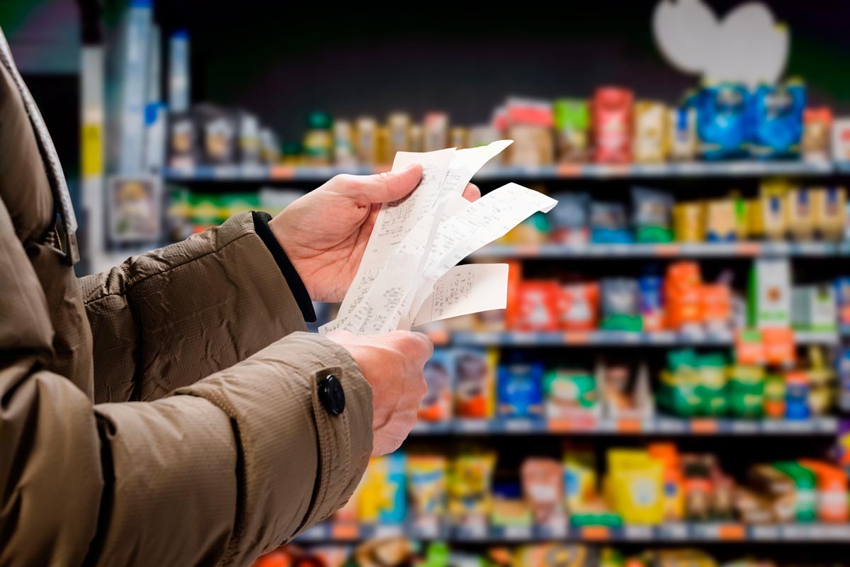 Hands holding receipt in grocery aisle