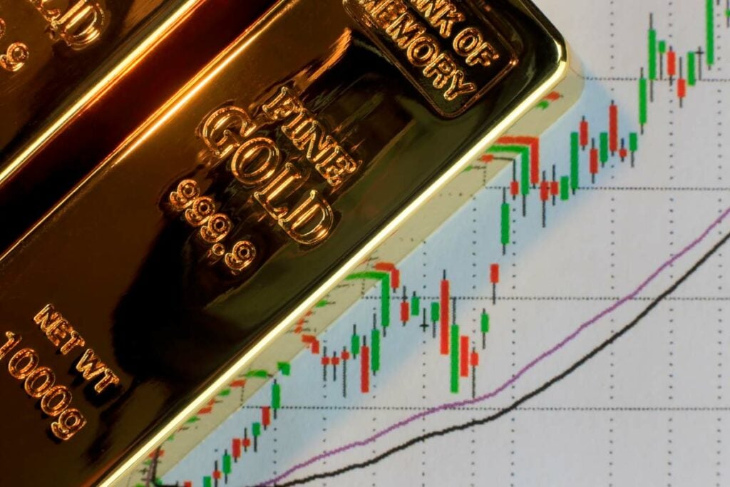 Gold bars on top of upward-trending data chart