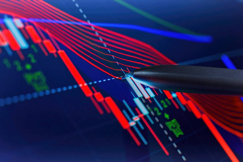 Pen pointing to spot on price data chart