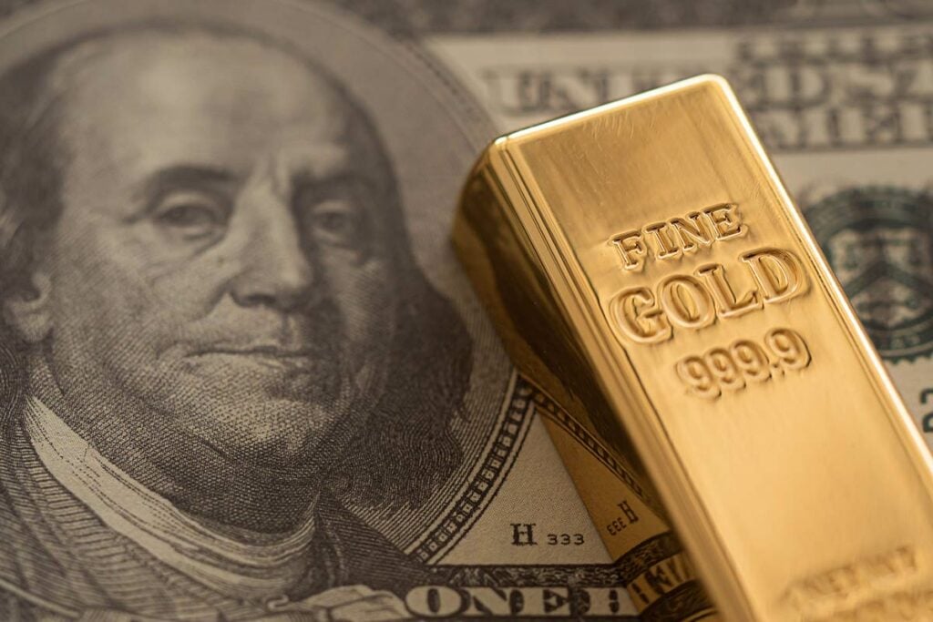 Gold bar over $100 note